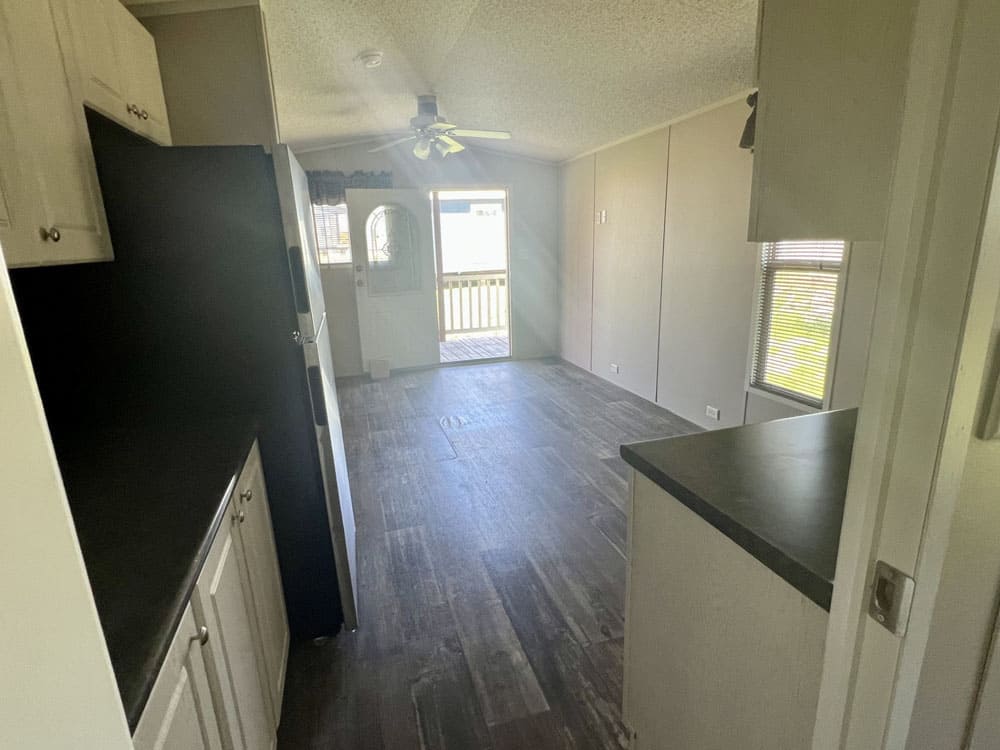 Galley kitchen overlooking the living room and front porch