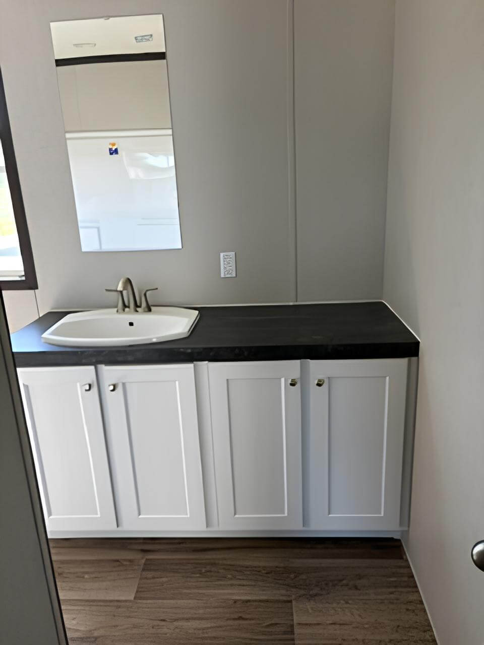 Guest bathroom vanity in The Blitz manufactured home