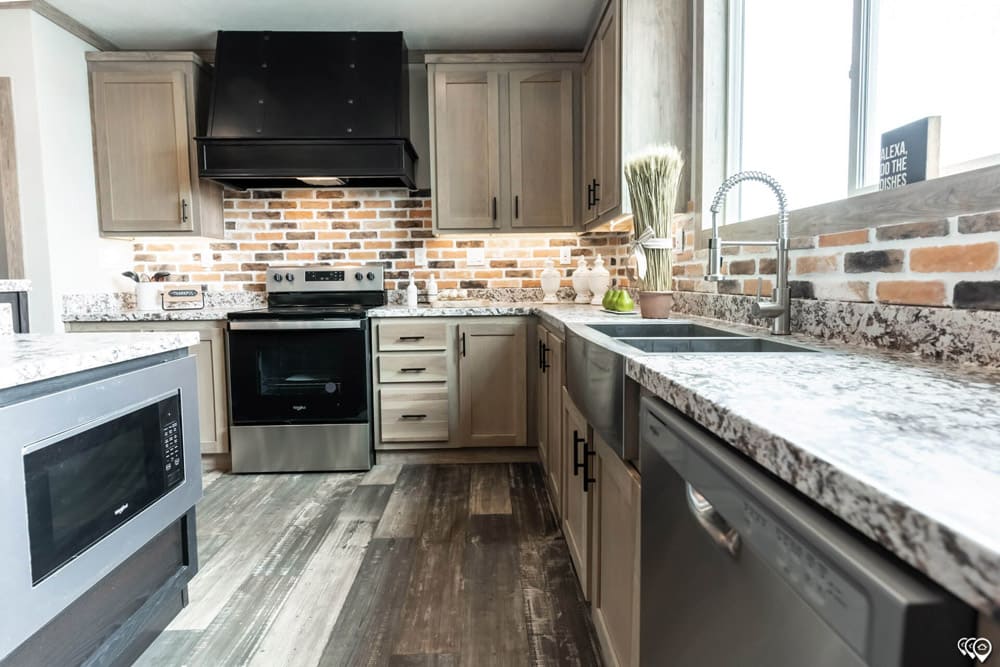 Farmhouse kitchen with brick backsplash in The Shoal Creek