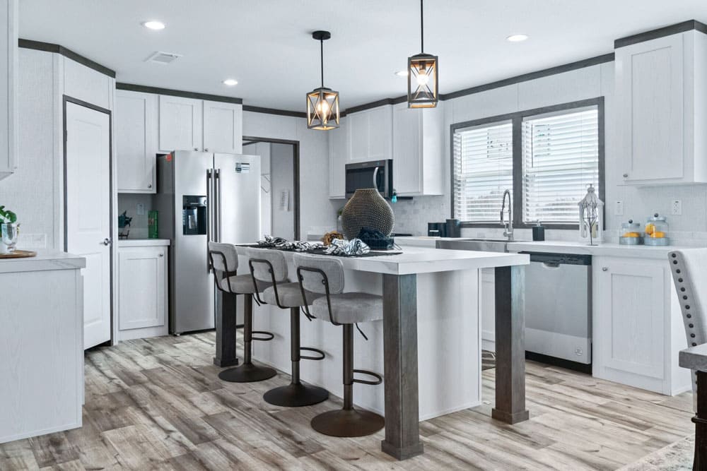 Jessup Royal kitchen island with bar seating and pendant lights
