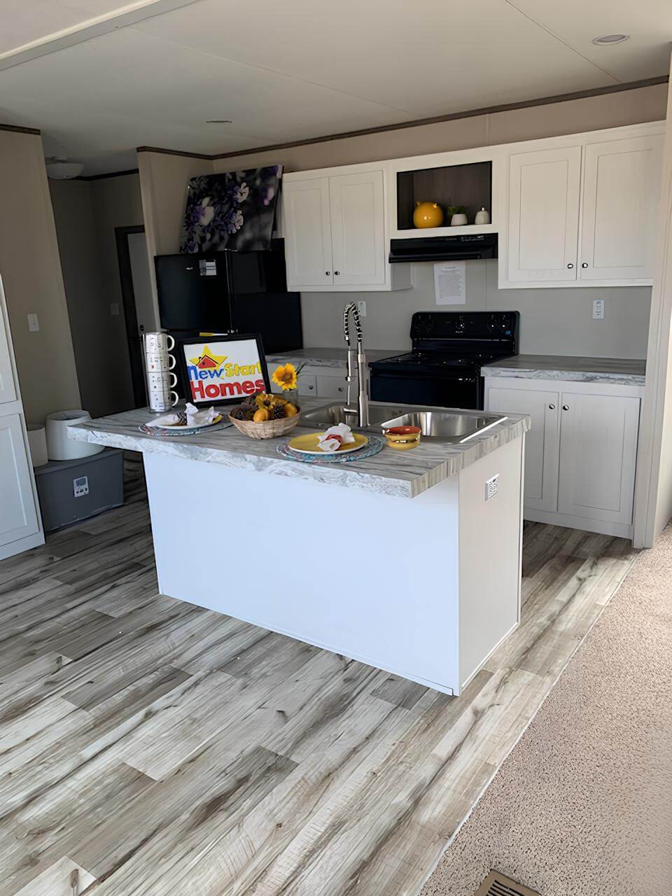 Modern island kitchen in The Cuatro four-bedroom home in Greenville, TX