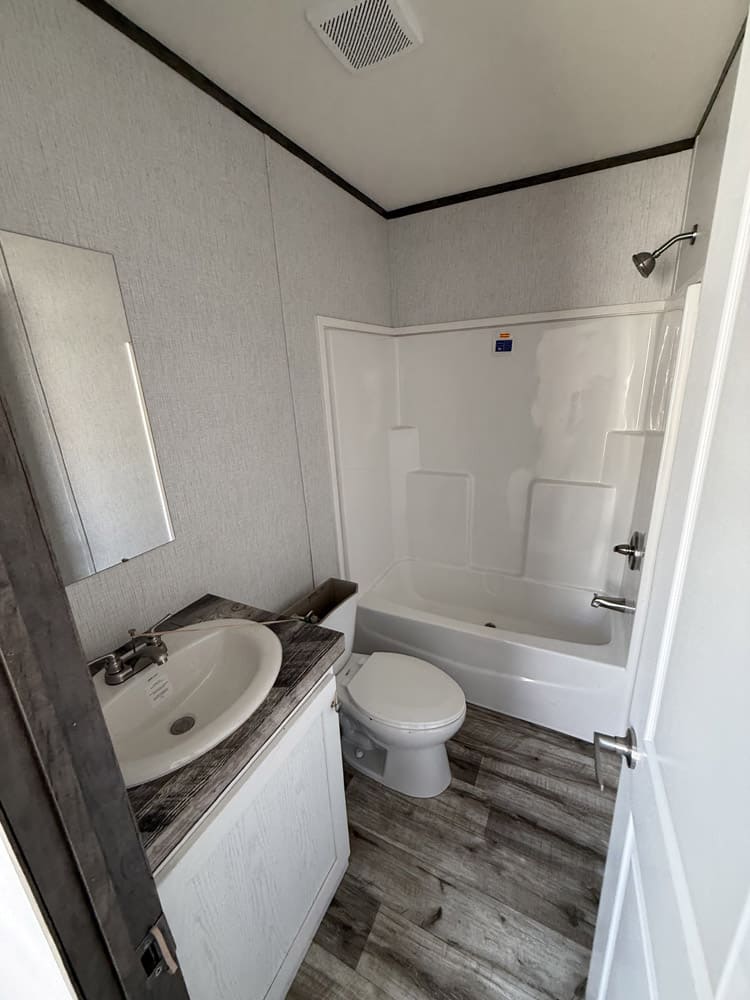 Bathroom with single vanity and tub-shower combination in the Jessup Jackson home in El Paso