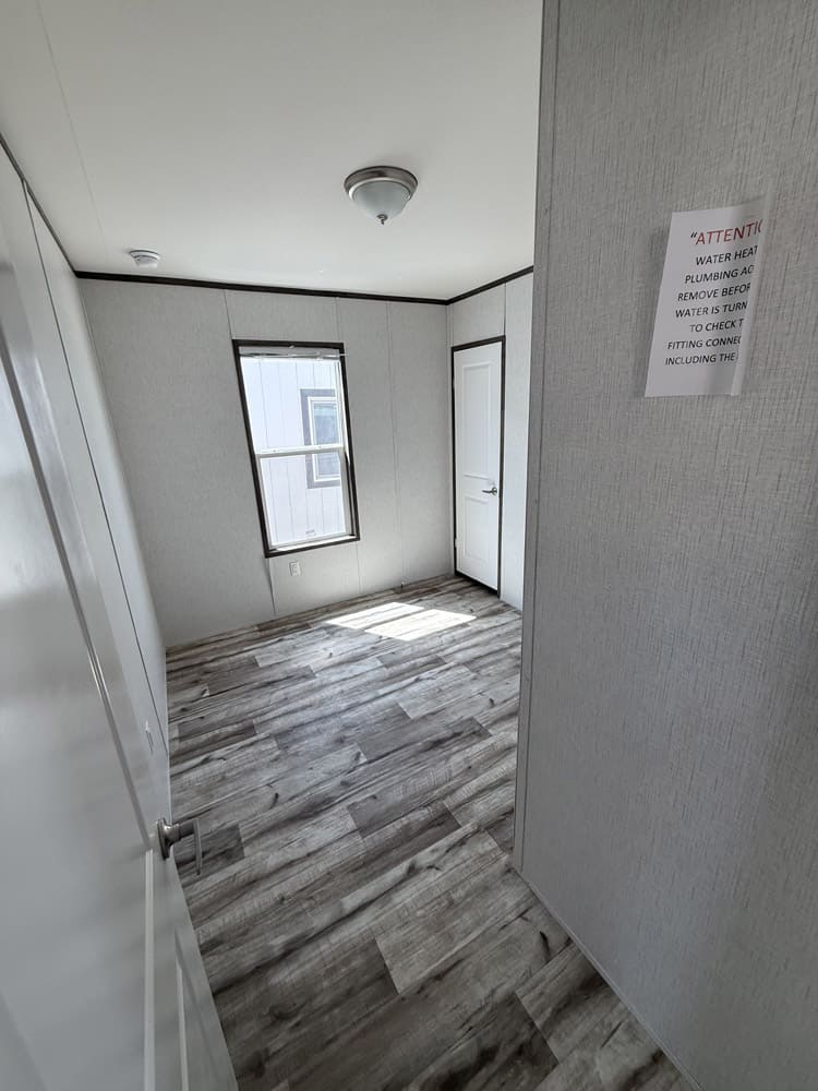Bedroom viewed through its doorway in the Jessup Jackson 3-bedroom manufactured home
