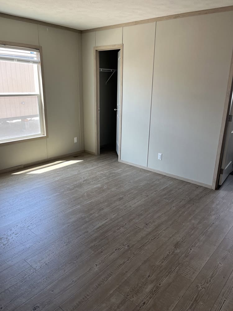 Bedroom and closet doorway in the Clayton Epic Mariner 16x80 home in El Paso