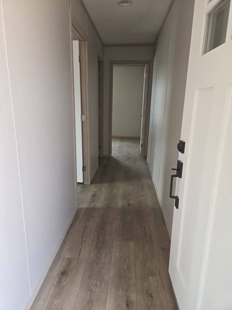 Hallway from the rear entry toward the bedrooms in the Clayton Epic Hudson 16x76 home in El Paso