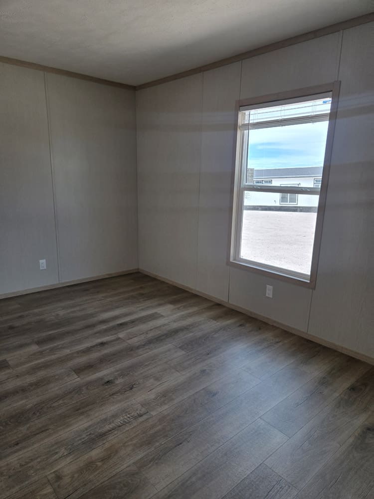 Bedroom with single window in the Clayton Epic Hudson 16x76 home in El Paso