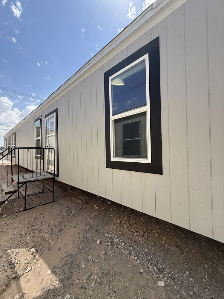 Entry side with dark window trim in the Jessup Jackson 3-bedroom manufactured home