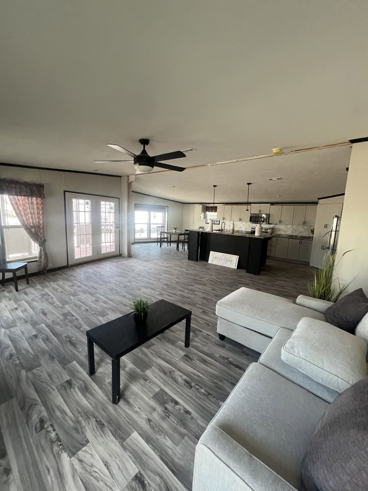 Furnished living room with sectional and coffee table in the Legacy FG-H-326432AD home in El Paso