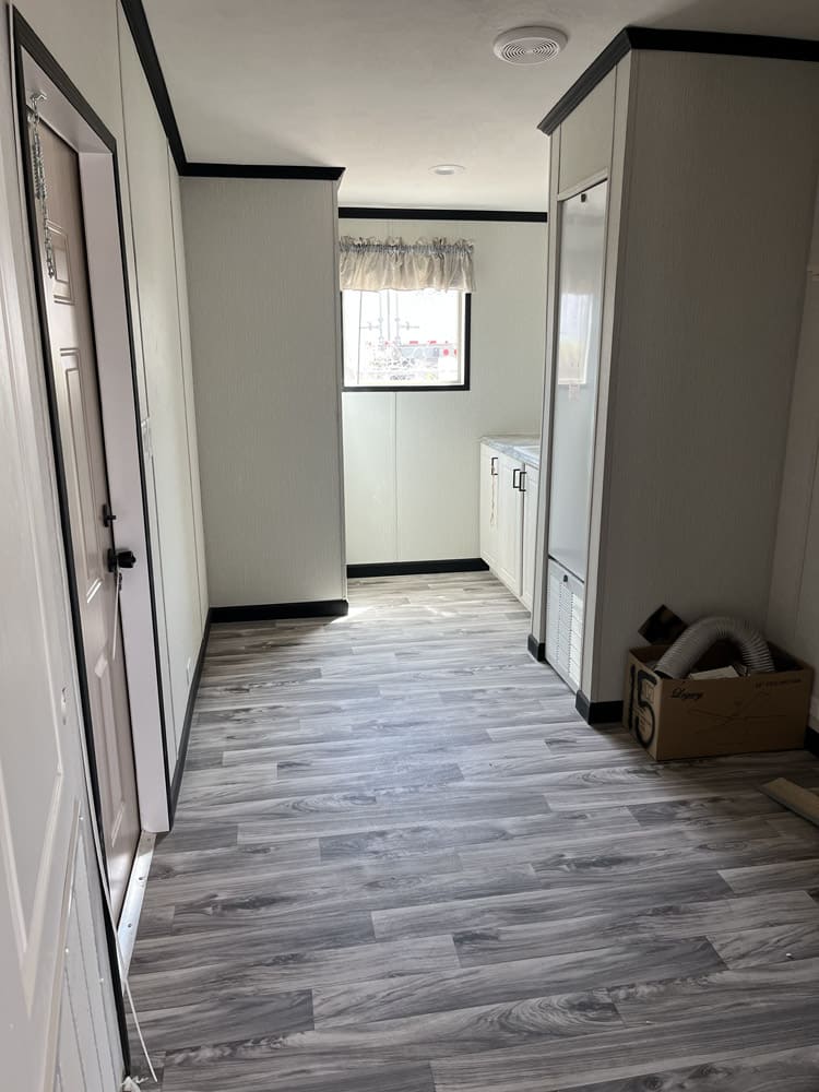 Laundry room with storage cabinetry in the Legacy C-3256-32B 3-bedroom manufactured home
