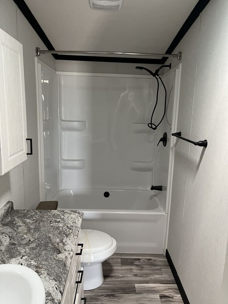 Secondary bathroom tub-shower combination in the Legacy C-3256-32B 3-bedroom manufactured home