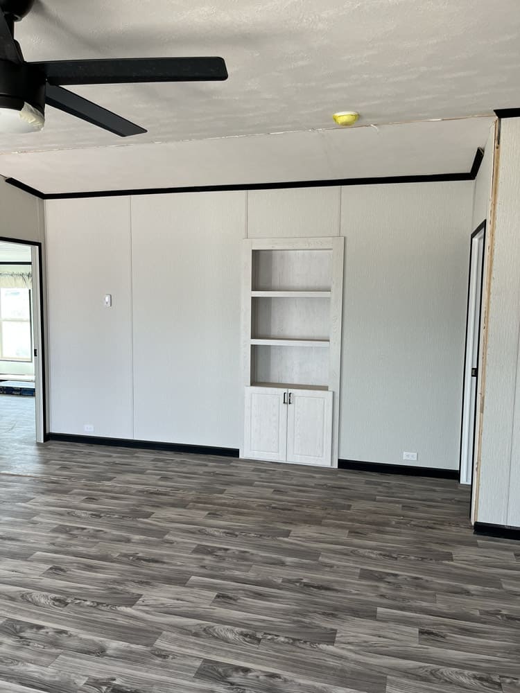 Living room with recessed display shelves in the Legacy C-3256-32B 3-bedroom manufactured home