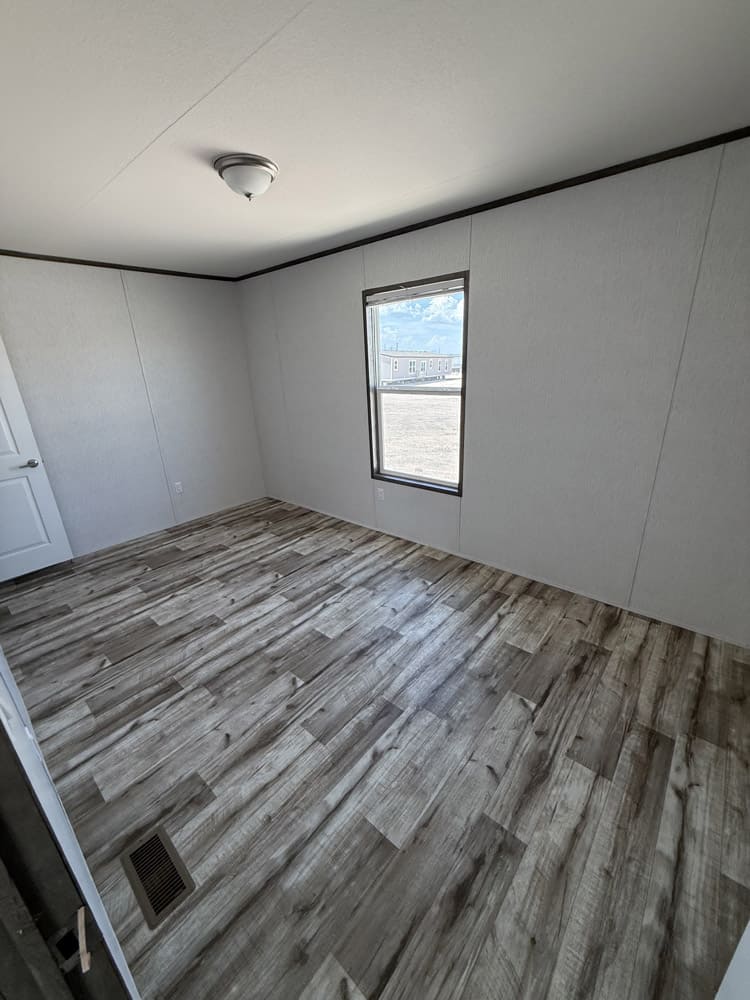 Bedroom with one window in the Jessup Jackson 16x76 home in El Paso