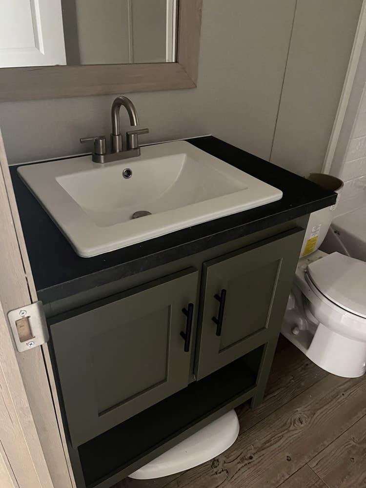 Green single vanity with rectangular sink in the Clayton Epic Mariner home in El Paso