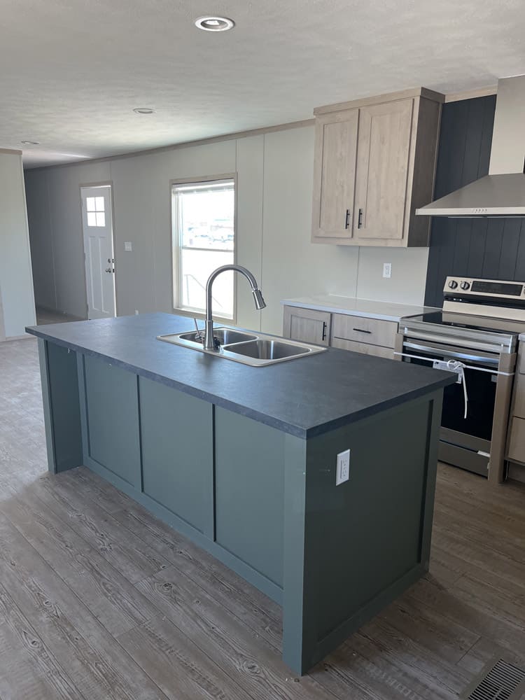 Double sink in the green kitchen island in the Clayton Epic Mariner 3-bedroom manufactured home