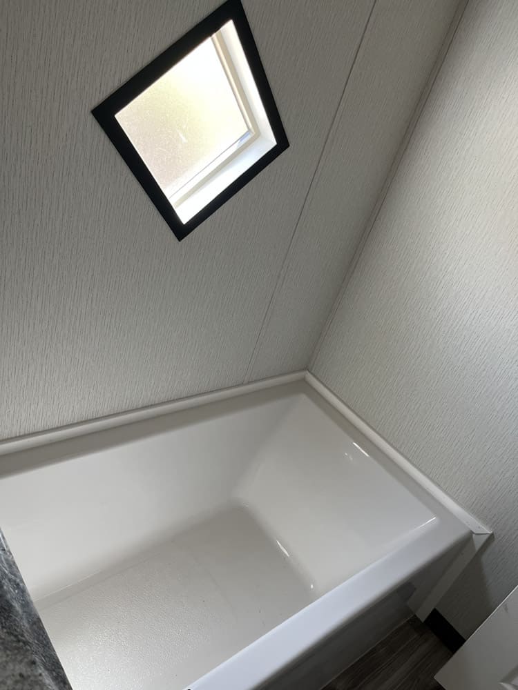 Bathtub beneath a frosted window in the Legacy C-3256-32B home in El Paso