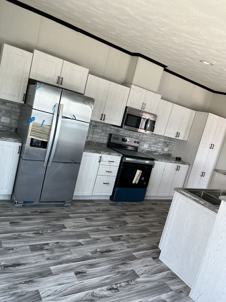 Kitchen with stainless refrigerator and range in the Legacy C-3256-32B home in El Paso