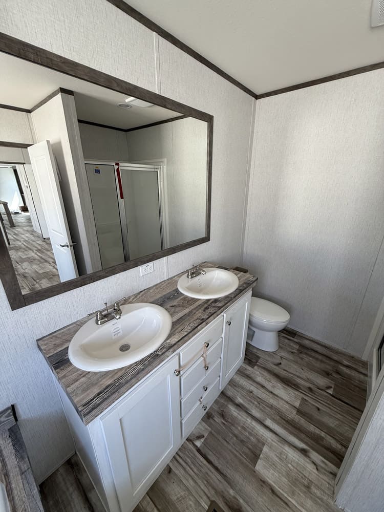 Double bathroom vanity with a wide mirror in the Jessup Jackson home in El Paso