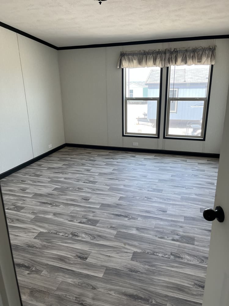 Bedroom with two windows in the Legacy C-3256-32B home in El Paso