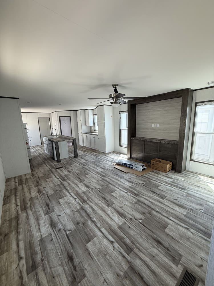 Open living area and kitchen with built-in media cabinetry in the Jessup Jackson home in El Paso