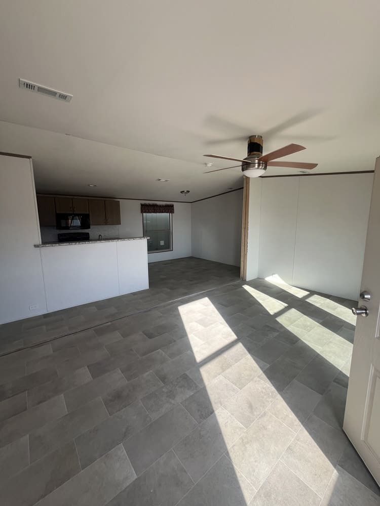 Open living area facing the kitchen in the Legacy S-2468-42A 4-bedroom manufactured home