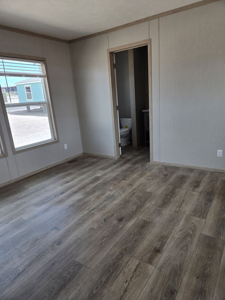 Bedroom with adjoining bathroom doorway in the Clayton Epic Hudson home in El Paso