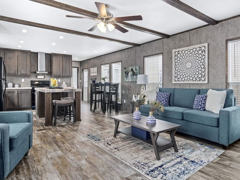 Open-concept living room, kitchen and dining area in The Grant 3-bedroom manufactured home