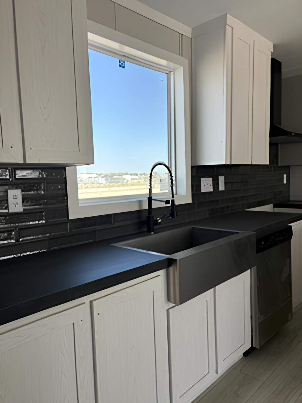 Farmhouse kitchen sink and black backsplash in doublewide #180
