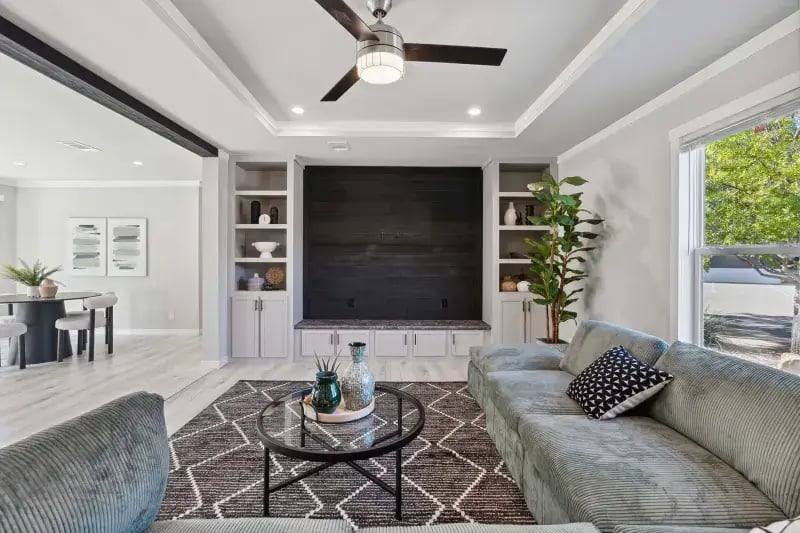 Living room with built-in entertainment center and tray ceiling in The Carol 4-bedroom home