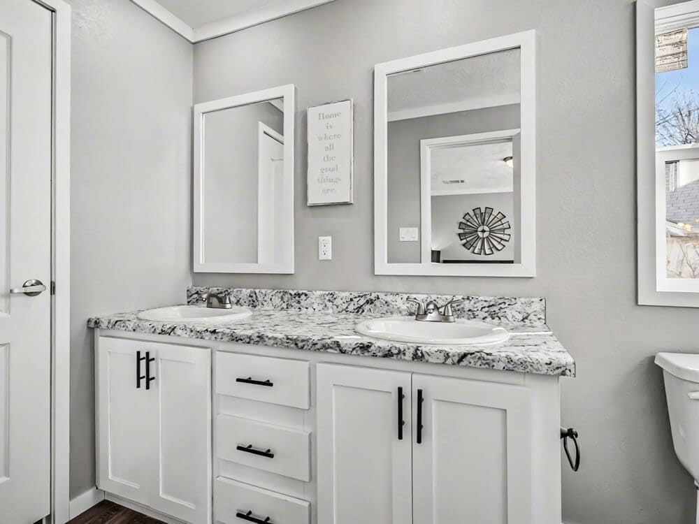 Bathroom vanity and mirror in the one-bath Bobby Jo manufactured home