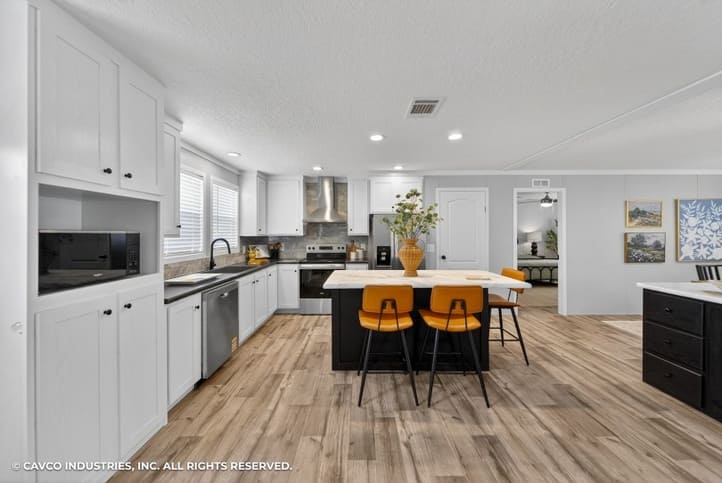 Open kitchen with island seating in The Vantage, a 1,680 sq. ft. manufactured home