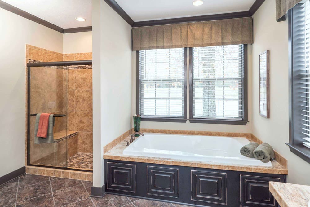 Soaking tub and tiled walk-in shower in The Nandina primary bath