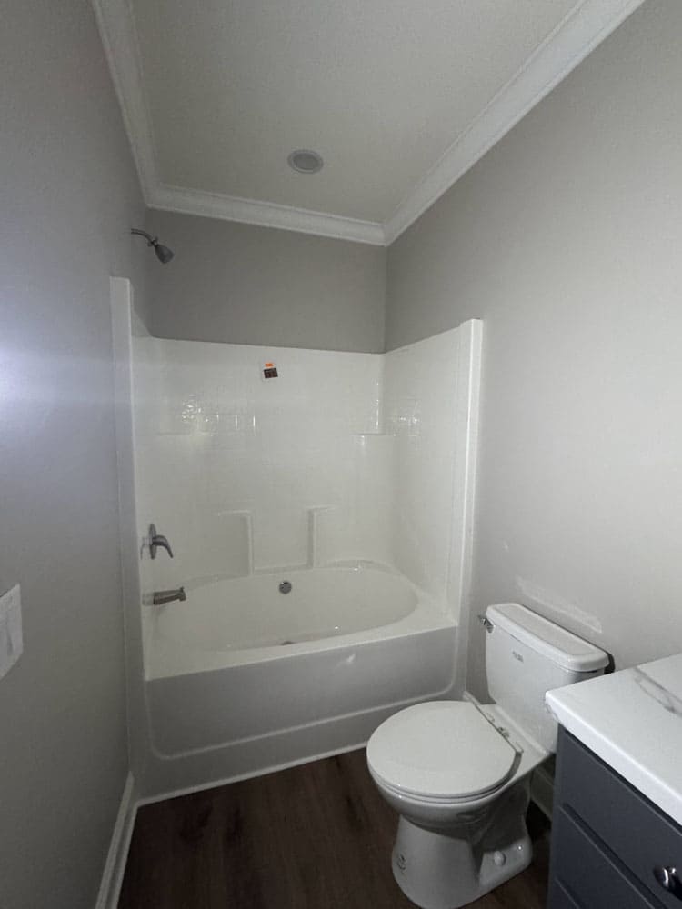 Guest bathroom with tub and shower in The Lilly II prefab home