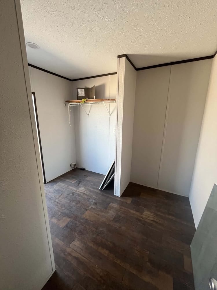 Laundry alcove with overhead storage shelf in Cavco 28x72 home #3254 at New Start Homes in El Paso, TX