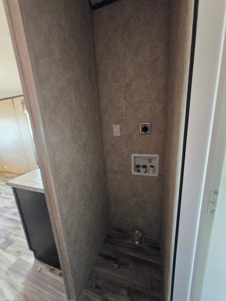 Alcove with stackable washer and dryer connections in Legacy Housing S-1236-11FLA 12x36 home #5915 at New Start Homes in El Paso, TX