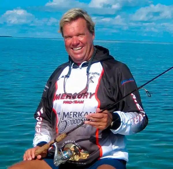 Fin-Tastic Charters captain on the boat with a fishing rod