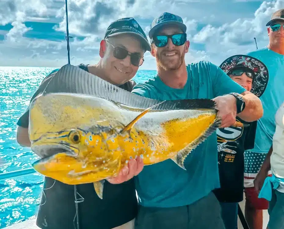 Two anglers holding a fish they caught in Islamorada