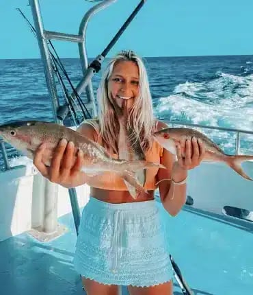 Woman holding a fresh catch on a party boat in Islamorada