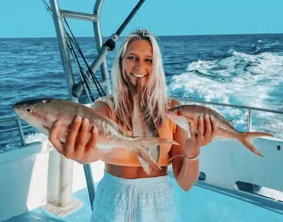 Girl holding her catch at Robbie’s