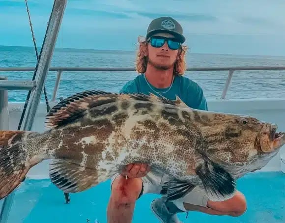 Angler holding a big catch at Robbie’s