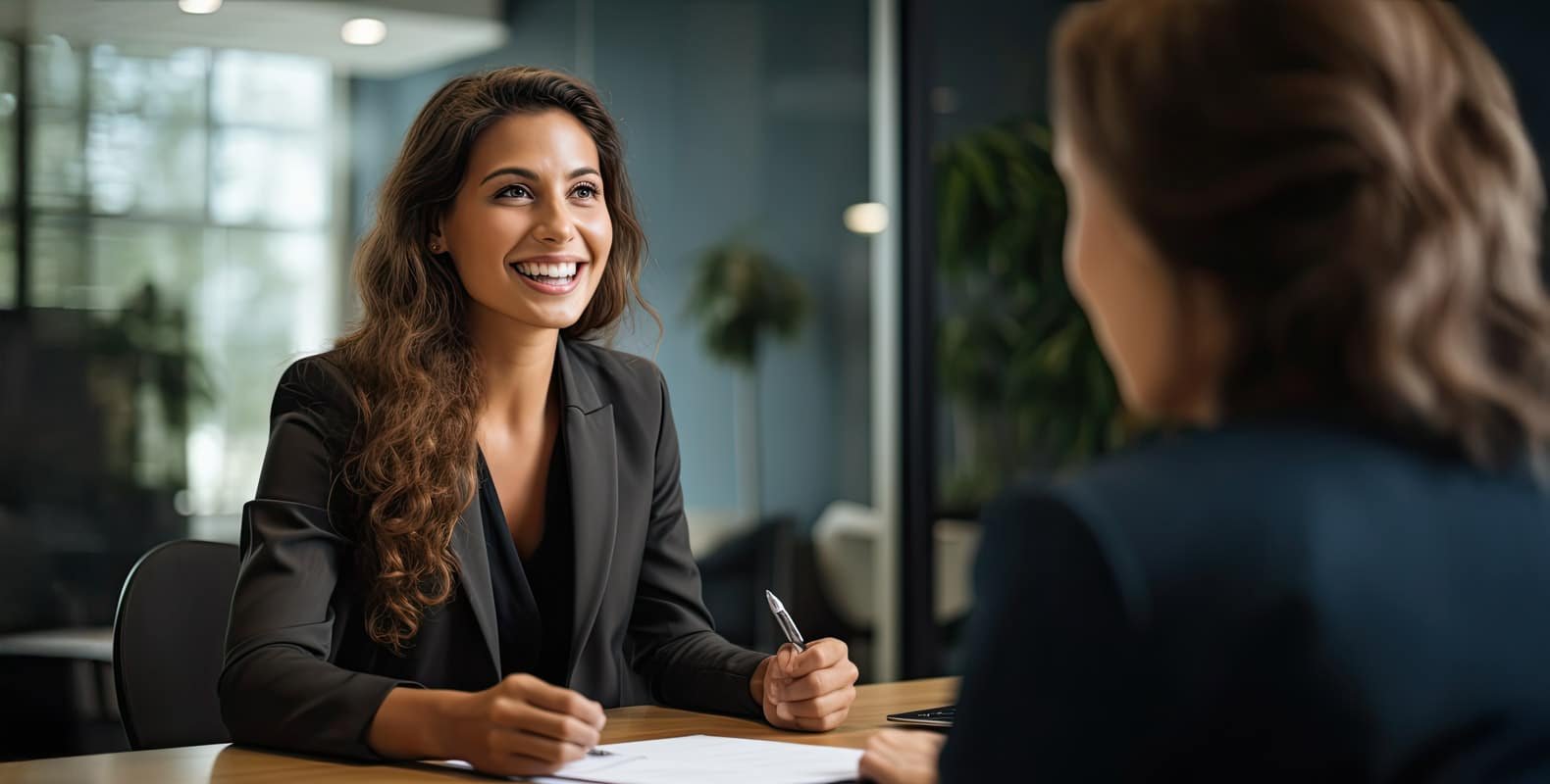 A confident businesswoman smiling during a professional meeting.