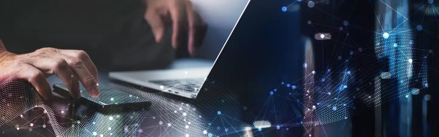 A person using a laptop, with digital network graphics overlaid, symbolizing technology and connectivity.