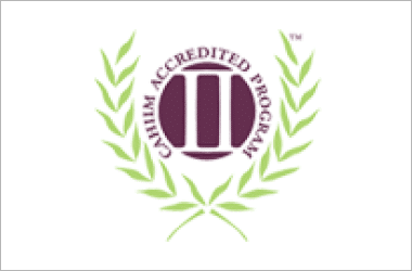 CAHIIM Accredited Program logo featuring a maroon emblem surrounded by green laurel branches on a white background.