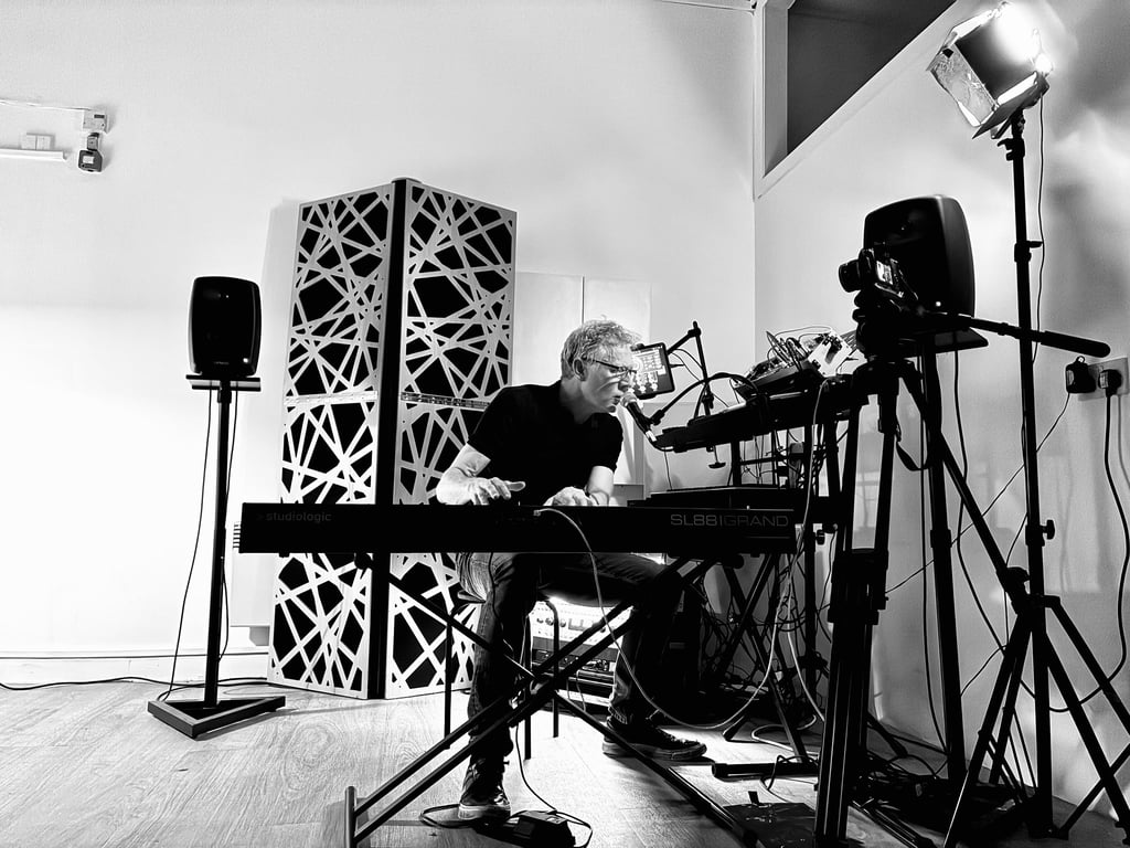 Giles Lamb performing live at a keyboard, black and white