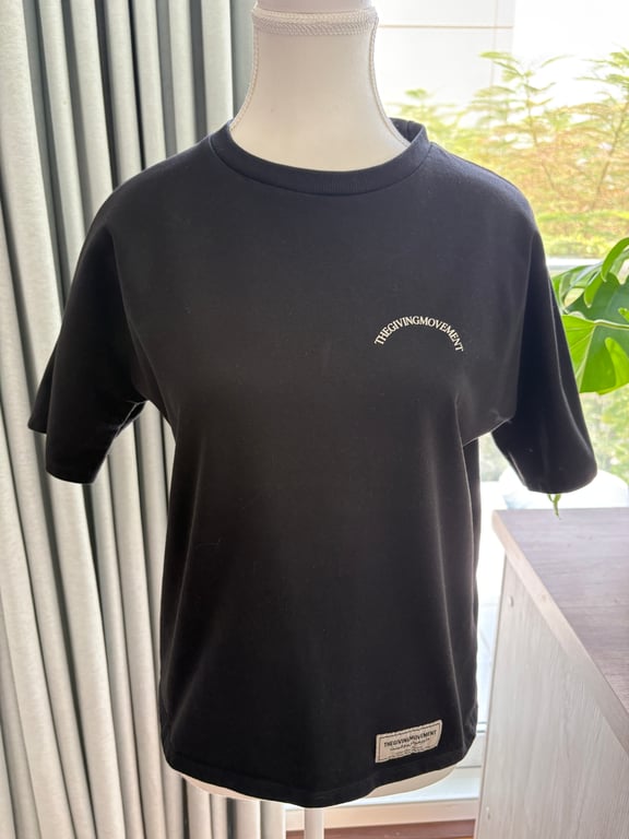 The Giving Movement — The Giving Movement Kids Black T-Shirt (Size 12Y, Good)