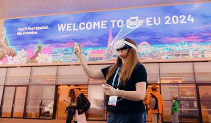 Person using AR devices at tech event, highlighting AR technology and AR experiences.