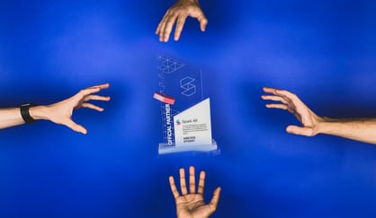 AR award trophy surrounded by hands over a blue background.