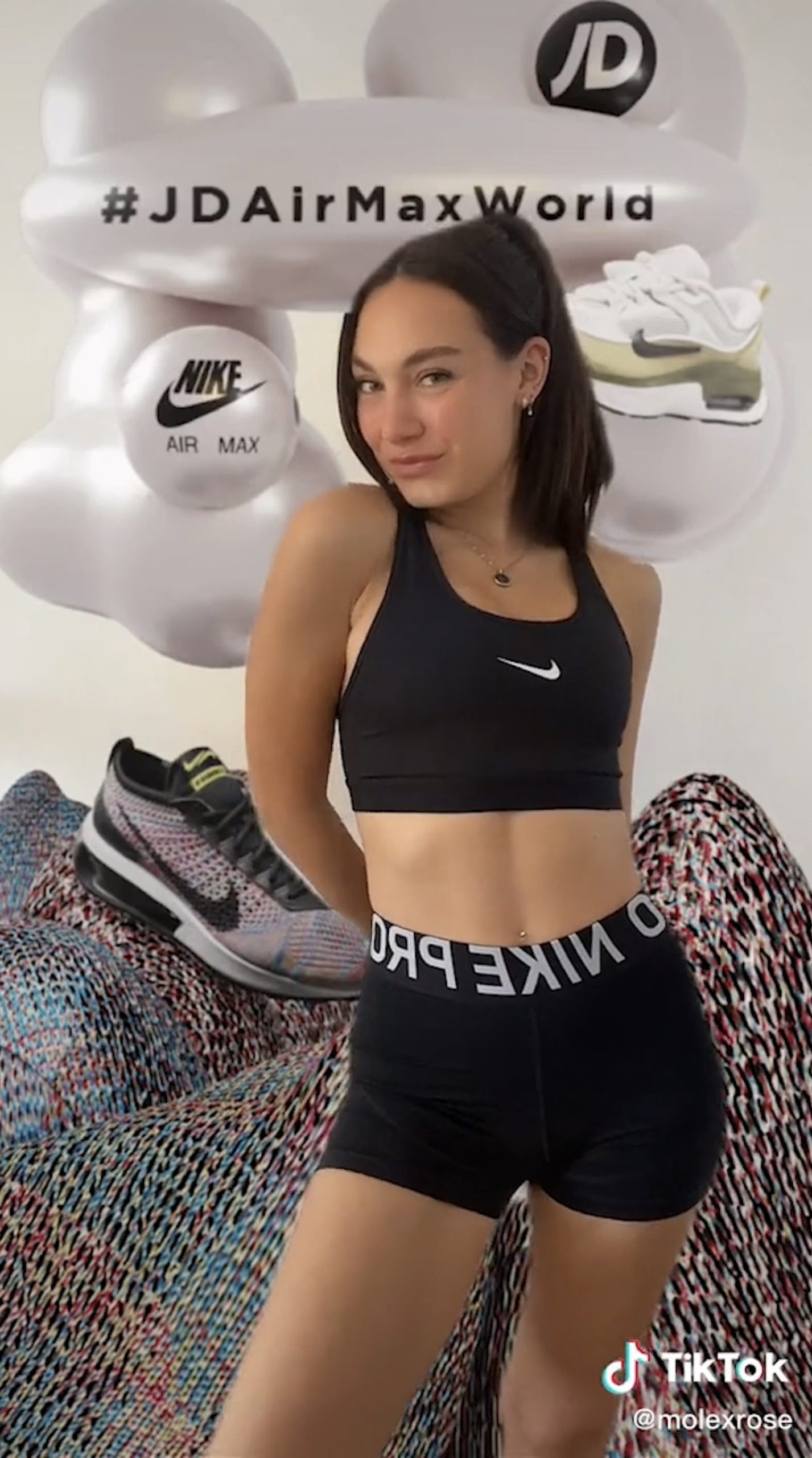 Screenshot depicting a young female using an AR filter developed in the AIRMAX identity as part of JD Sports' campaign for TikTok.