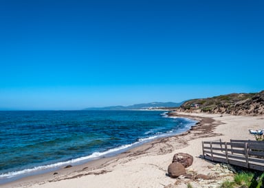 La Ciaccia Kiteboarding in Italy view from the sandy beach with the blue ocean very calm and sunny