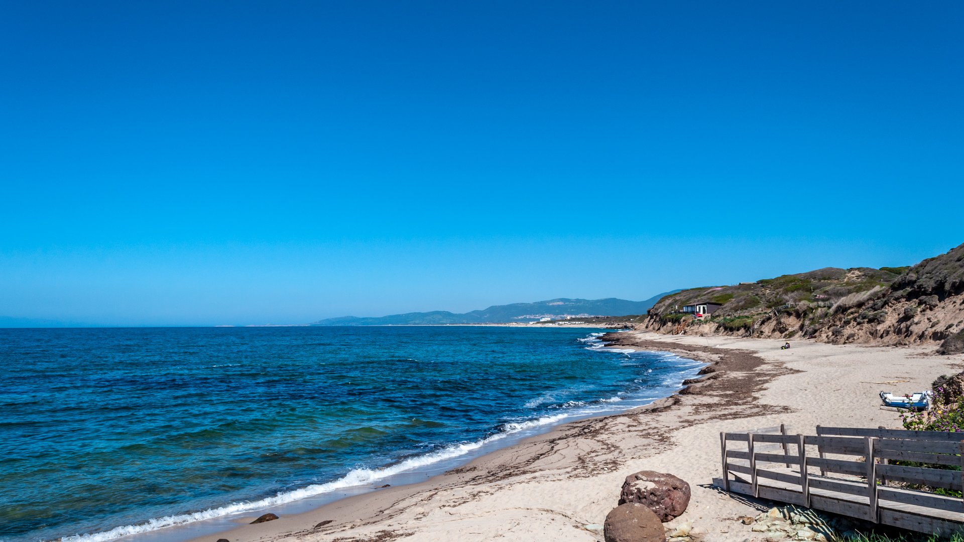La Ciaccia Kiteboarding in Italy view from the sandy beach with the blue ocean very calm and sunny