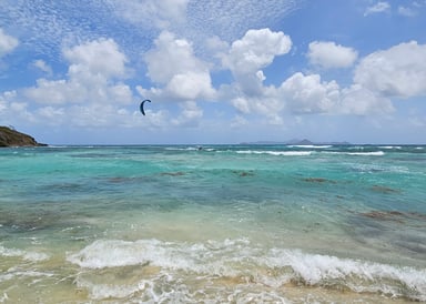 View on mini Waves at Mayreau Island with few people kitesurfing